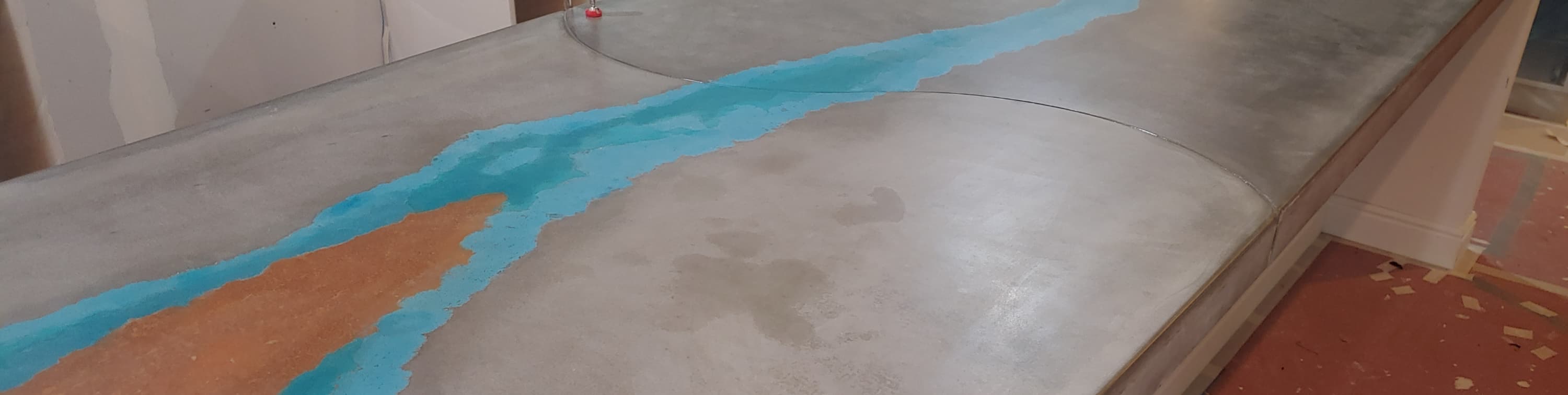 Grey concrete top with a turquoise and rust river inlay