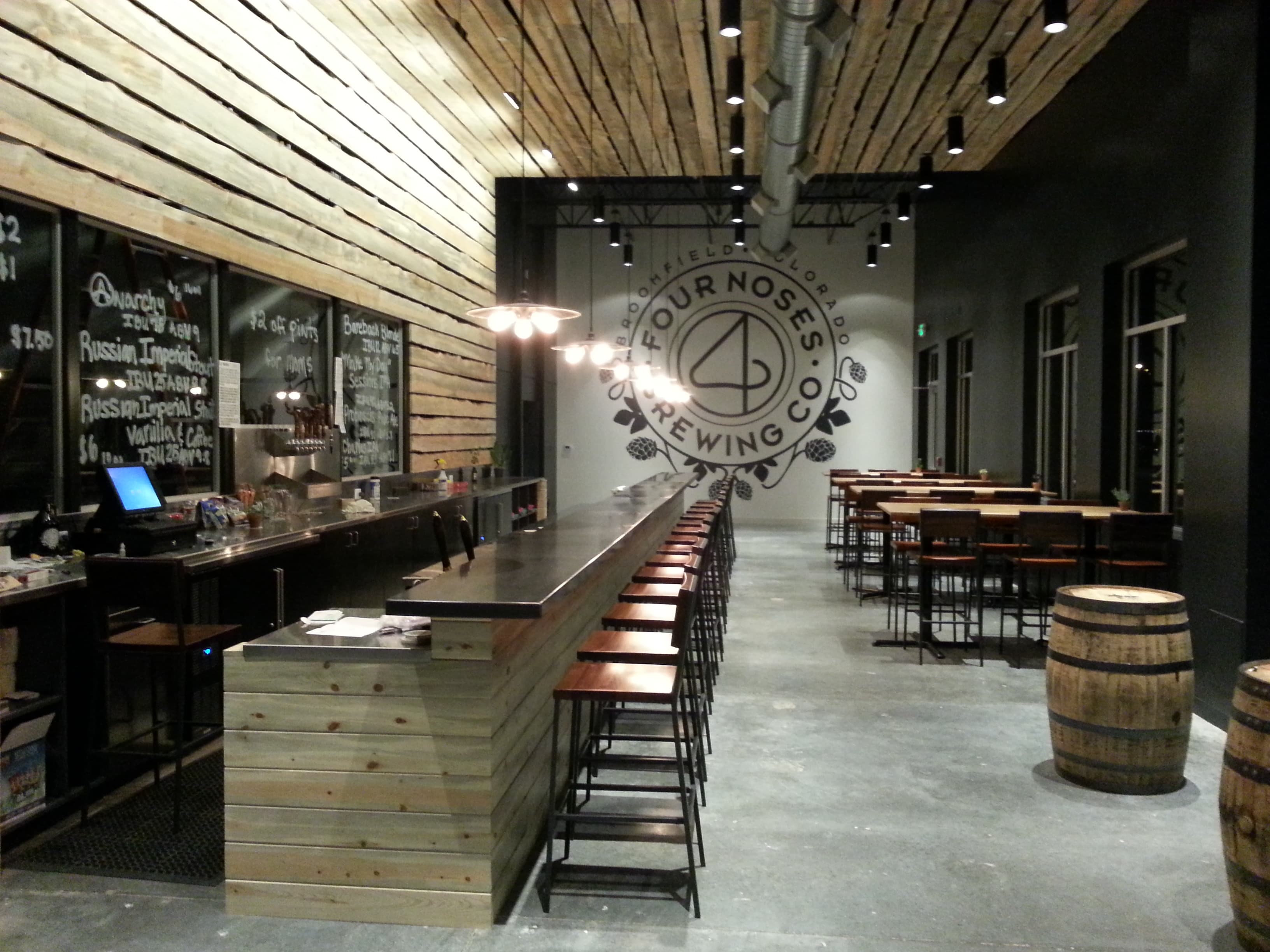 Long brewery bar with a concrete top and wood front